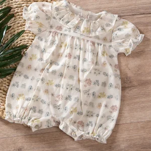 Pagliaccetto neonata in tela di cotone organico con balza allo scollo e maniche a palloncino